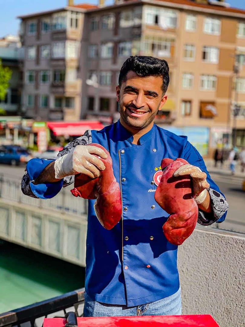photo of a chef holding livers
